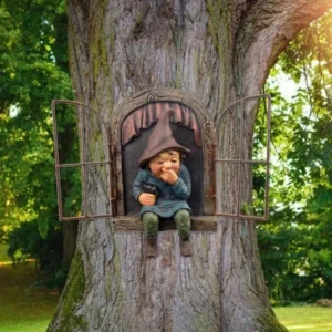 Garden gnome in a tree window, holding a bird. Whimsical garden decor.