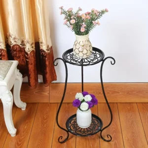 Black metal plant stand with two tiers, displaying flowers in vases. Decorative home accent.