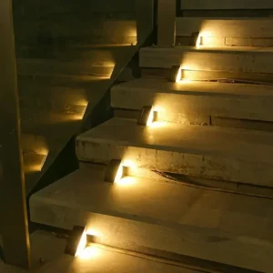 Staircase with embedded step lights illuminating the treads, providing safe passage.