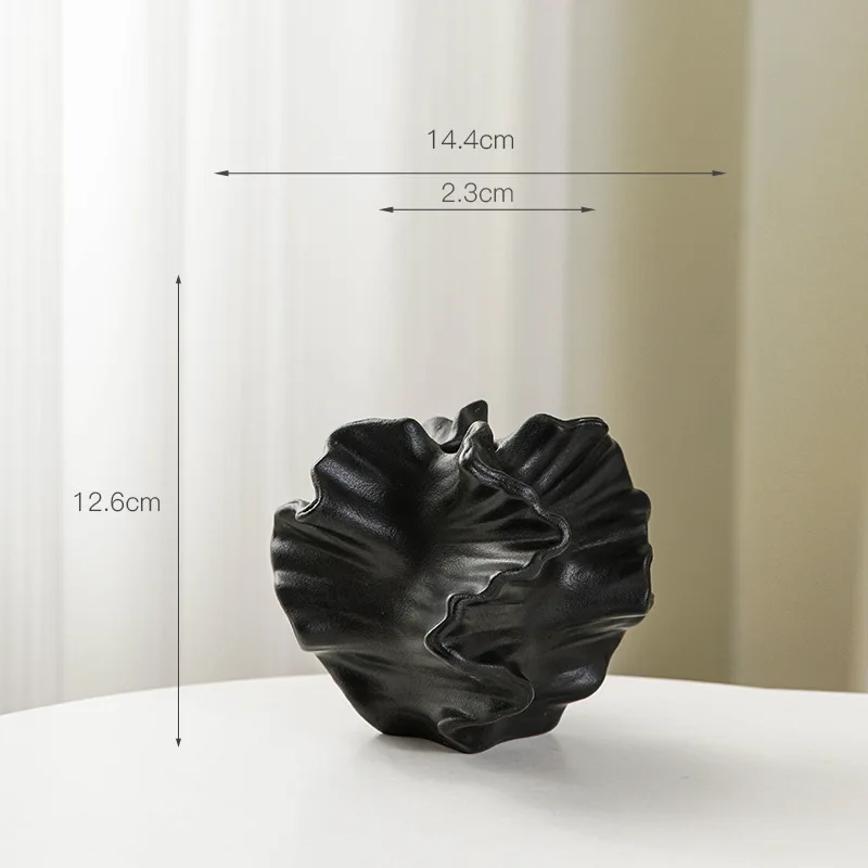 Black ceramic vase with ruffled edges, approximately 12.6cm tall and 14.4cm wide.