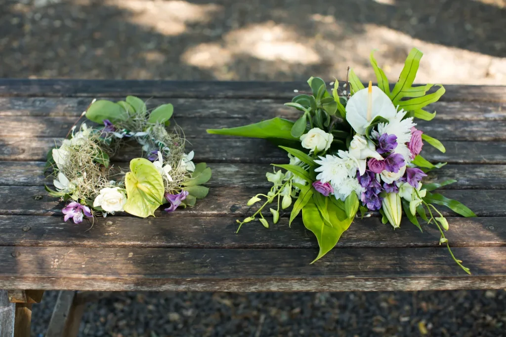 Elegant floral wreath and bouquet for a natural tribute on a wooden bench