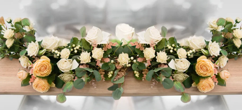 Elegant floral arrangement with white and peach roses for a natural tribute